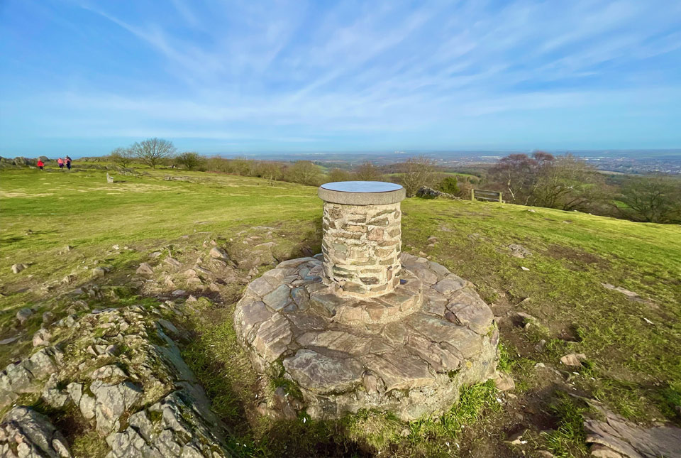 a picture of a stone statue on top of beacon hill in Leicestershire